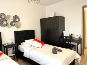 a bedroom with two beds and two tables and a mirror at Albert's apartment Center 101 in Larnaca +6 photos