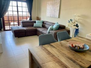 a living room with a couch and a table at Balcon del Mar A&V Ocen View Costa del Silencio in Costa Del Silencio