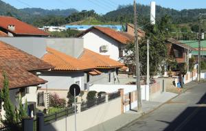a city street with white houses with orange roofs at Casatua in Pomerode