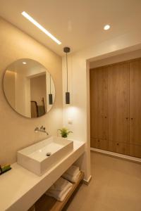 a bathroom with a sink and a mirror at KAMEO, Antiparos in Antiparos