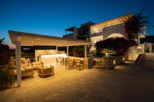 a patio with a table and chairs in front of a building at KAMEO, Antiparos in Antiparos