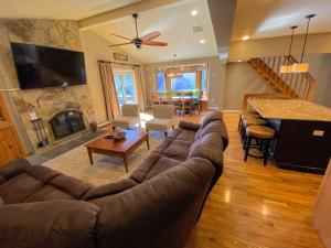 a living room with a couch and a fireplace at O7 Slopeside Bretton Woods Resort cottage with upscale stylings cozy decor tons of space in Carroll