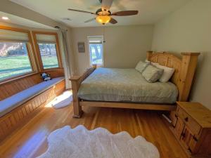 a bedroom with a bed with a fan and a window at O7 Slopeside Bretton Woods Resort cottage with upscale stylings cozy decor tons of space in Carroll