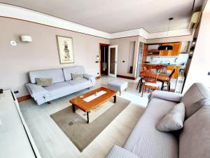 een woonkamer met een bank en een tafel bij Apartment 13 - Your Perfect Stay in Durres City in Durrës