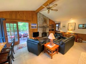 a living room with a couch and a fireplace at O9 NEW Renovated Bretton Woods slopeside condo with 2 living rooms foosball air hockey in Carroll
