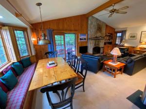 a dining room and living room with a table and chairs at O9 NEW Renovated Bretton Woods slopeside condo with 2 living rooms foosball air hockey in Carroll