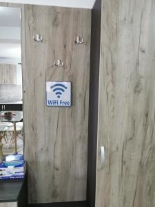 a door with a wifi free sign on it at Apartament Ovidiu in Giroc