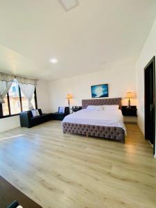 1 dormitorio grande con 1 cama y 1 sofá en Habitación Ejecutiva cómoda y acogedora - Centro de Manta, en Manta