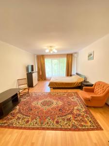 a living room with a bed and a rug at Villa Park 411 in Odesa