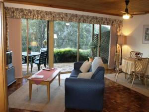 a living room with a couch and a table at Tweed Valley Lodge in Bridgetown