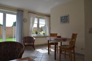 a dining room with a table and chairs and a window at Buttgereit in Kosel