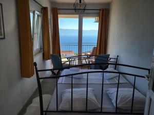 a bedroom with a bed and a view of the ocean at Villa Belle Vue in Čelina