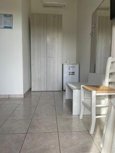 a living room with a table and a refrigerator at Agriturismo Tenuta Pozzello in Torre dell'Orso +34 photos