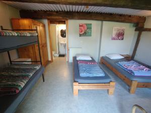 a room with two bunk beds and a chair at La Ferme de Werpin in Hotton