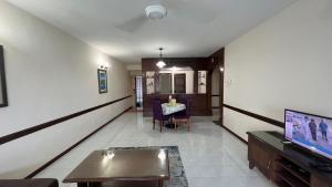 a living room with a tv and a table at Condo D 'Savoy 3 Room in Kampong Alor Gajah