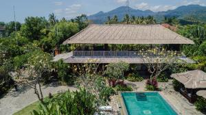 an aerial view of a resort with a swimming pool at Odiyana Bali Retreat in Banyuwedang