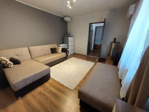 a living room with a couch and a table at Cozy, quiet & family friendly in Arad in Arad