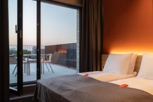 a bedroom with a bed and a view of a balcony at Citybox Antwerp in Antwerp