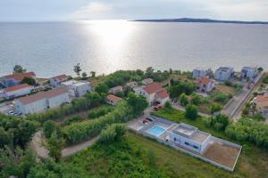 an aerial view of a house next to the water at Kuća za odmor Sara in Privlaka