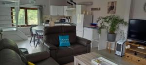a living room with a couch and a kitchen at Chez Stéphane in Rochefort +9 photos