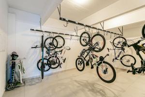 a room with several bikes hanging on a wall at WI-FI 200MB | 600m do Patio Milano #CA38 in Florianópolis
