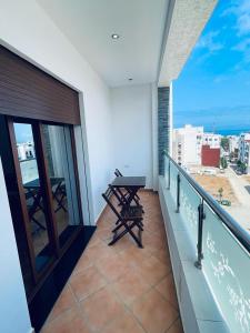 einen Balkon mit einem Tisch und Stadtblick in der Unterkunft Visit Oued Laou - Florencia in Oued Laou