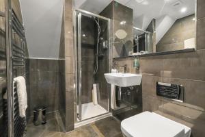 a bathroom with a shower and a sink and a toilet at The Duke on The Test in Romsey