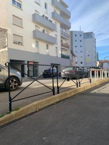a parking lot with cars parked in front of a building at LE 18 Dhuoda in Nîmes