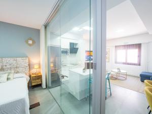 a bathroom with a glass shower in a bedroom at Cubo's Boutique Urban Deluxe in Alhaurín el Grande