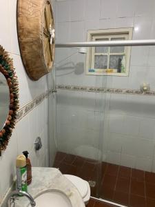 a bathroom with a shower and a toilet and a sink at Hostel Lumiar da Serra in Tiradentes