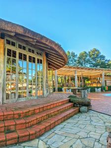 a building with a porch and steps in front at Vila Ventura Ecoresort in Viamão