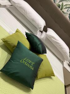 a group of pillows sitting on a bed at LOFT ORTENSIA in Pompei