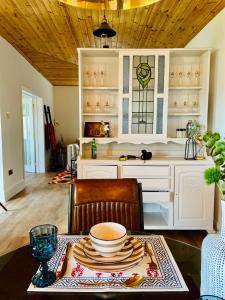 a kitchen with a table with a bowl on it at The Stables Hideaway in Llanelli