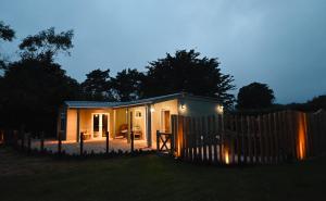 a small house in a yard at night at The Stables Hideaway in Llanelli