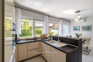 cocina con fregadero y 2 ventanas en Rooftop Spa, en Trogir