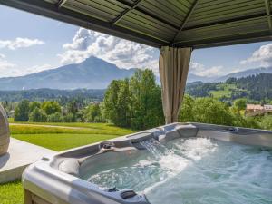 a hot tub with a view of a mountain at Kögei Hof in Going