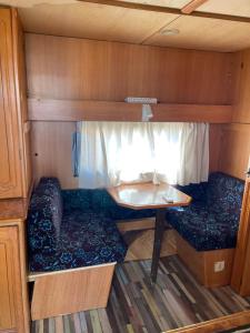 a small room with a table and a couch at SEA CARAVAN ON THE BEACH in Kiten