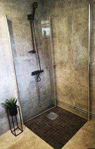 a shower with a glass door in a bathroom at Landvetter Apartment in Landvetter