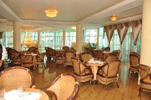 a restaurant with tables and chairs in a room at Friendship International Hotel in Addis Ababa
