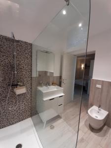 a bathroom with a sink and a toilet and a shower at Reggiolacittàinvisibile B&B in Reggio Emilia