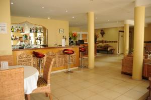 a restaurant with a table and chairs in a room at Hotel Maharajah in Mamoudzou