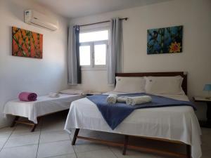 Ένα ή περισσότερα κρεβάτια σε δωμάτιο στο Deck de Búzios