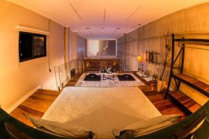 a large room with a table and a couch in it at Loft Industrial 485 na Serra - Bento Gonçalves in Bento Gonçalves
