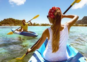 two women on a kayak in the water at Turismo Associativo Giovanile Europeo bidrino in Borgofranco dʼIvrea