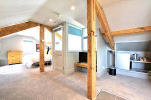 1 dormitorio con 1 cama y TV en una habitación en Fairfield House and Gardens, en Bowness-on-Windermere