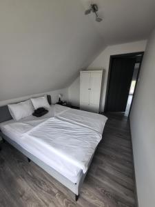 a bedroom with a large white bed with white sheets at Tiszavirág Üdülőház in Kisköre +26 photos