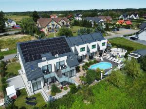 an aerial view of a house with solar panels on it at Apartamenty Polanki 2 in Łeba