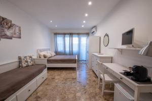 a small room with a bed and a desk in it at Casa Rosa Beige e Blu in Rome