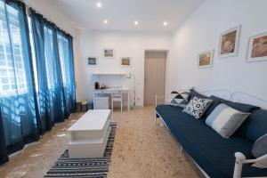 a living room with a blue couch and a table at Casa Rosa Beige e Blu in Rome