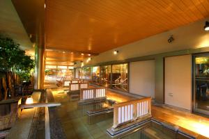 a row of benches in a building with windows at Yunokuni Tensyo in Kaga